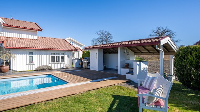 Badehuset har en overbygget sitteplass og en egen nisje med utedusj.