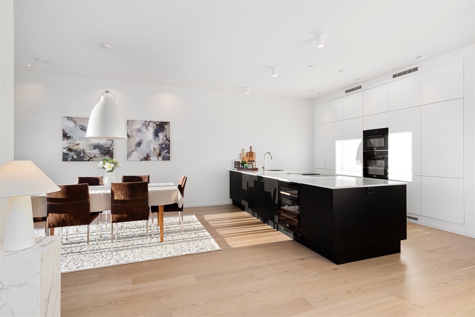 Kjøkken i åpen løsning mot stue med stor kjøkkenøy 