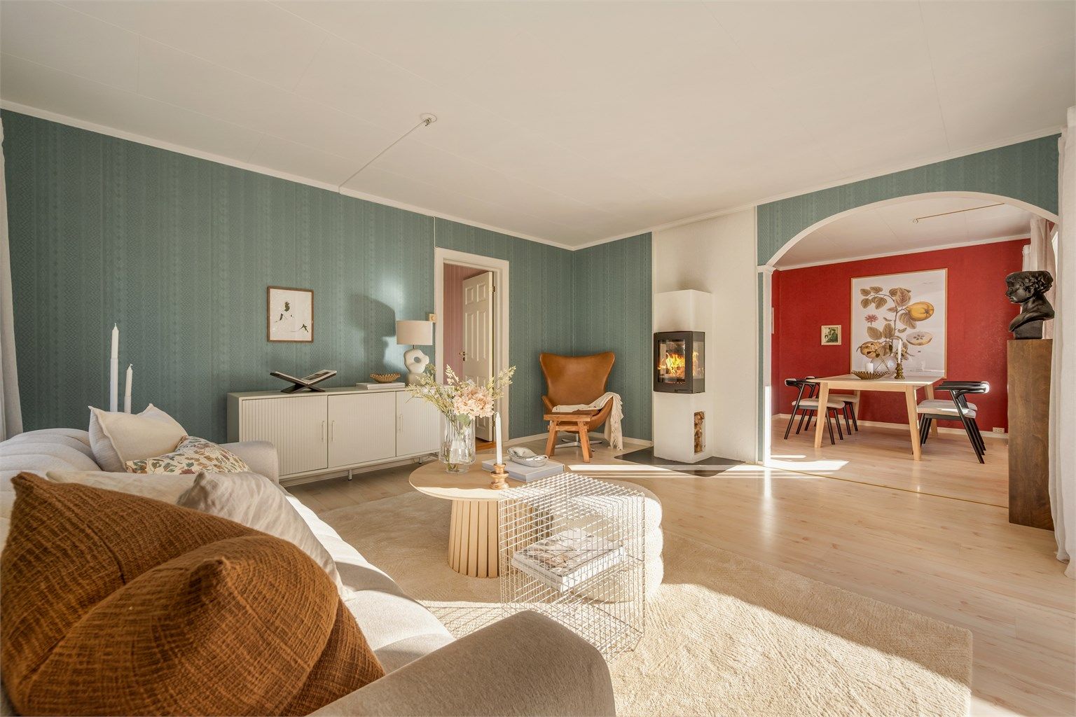 Stuen er utstyrt med en moderne peis, har buegang fra spisestuen og adkomst til soverommet.