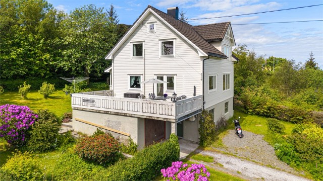 Eiendommen har en stor flott hage og garasje under terrassen.