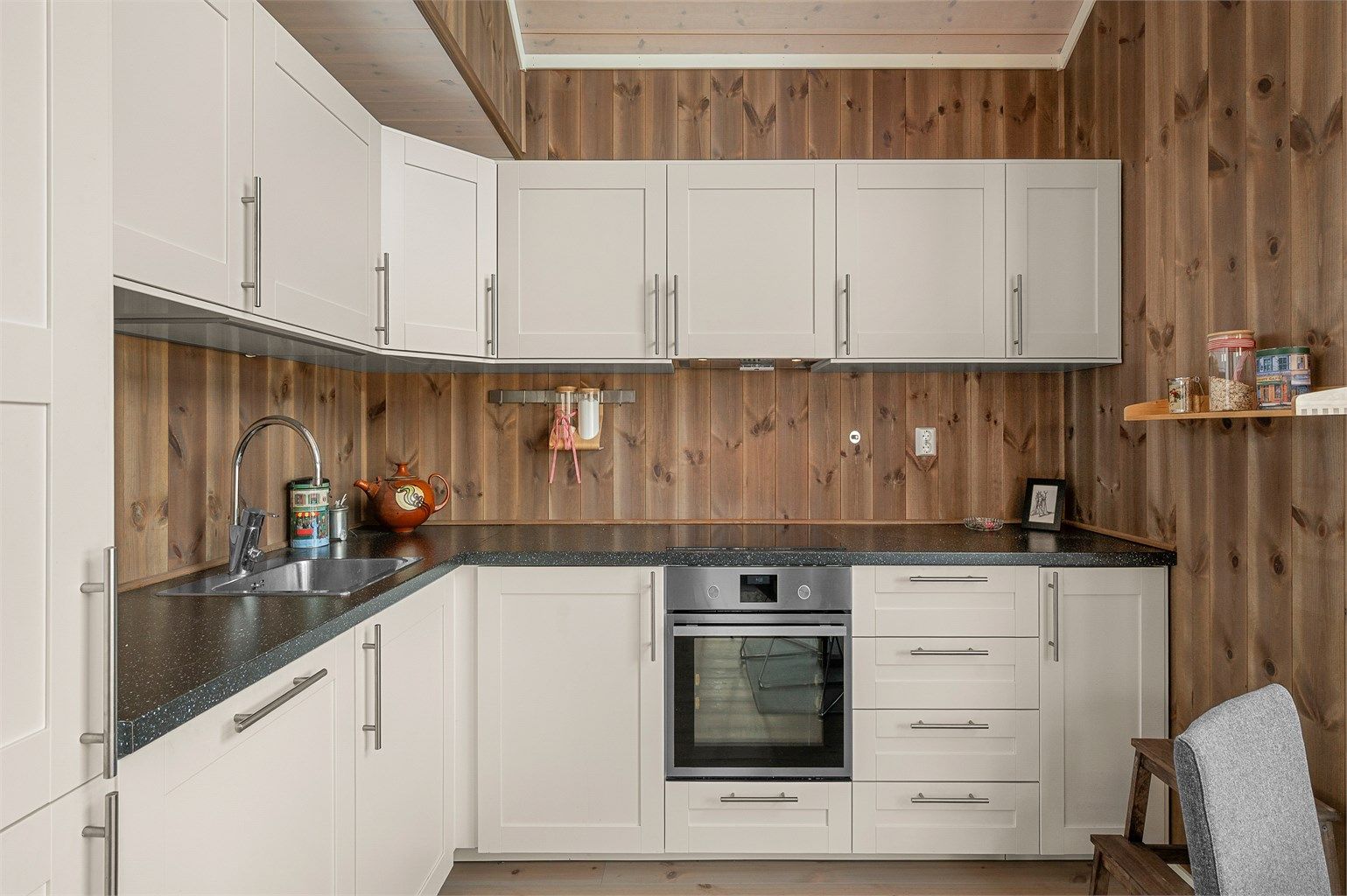 Moderne kjøkken fra 2018 med innredning fra Nordlyshytter, integrerte hvitevarer og praktiske arbeidsflater.