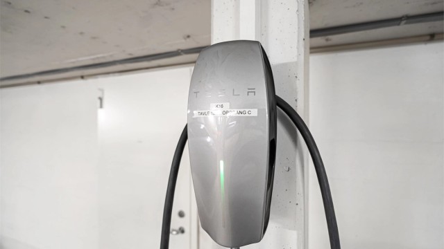 Tesla el-bil lader medfølger, svært praktisk med bod på hele 7 kvm i bakkant av parkeringsplassen