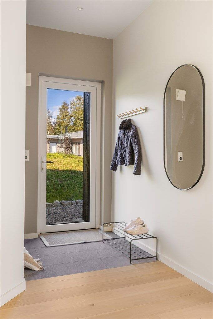 Inngangspartiet har et praktisk, flislagt gulv og leder deg videre inn i hytta.