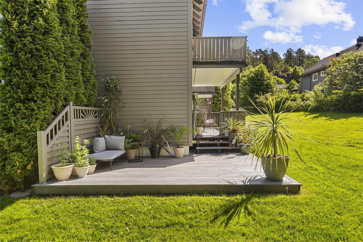 Den sydvestvendte terrassen er et naturlig samlingspunkt på varme dager.