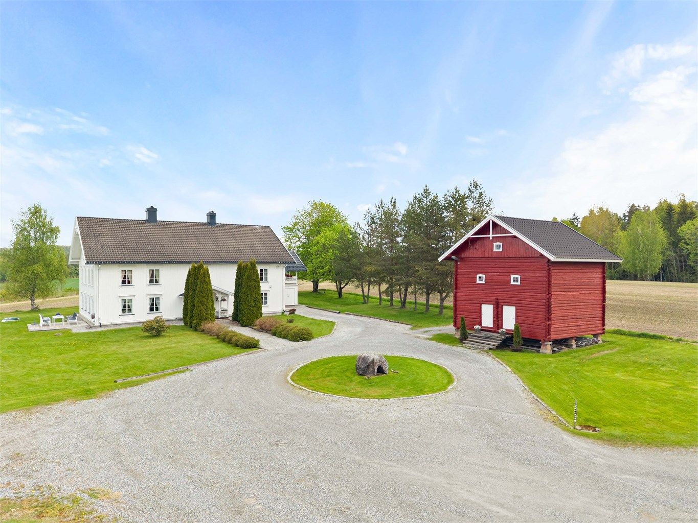 Oversikt over tunet med våningshuset og det laftede stabburet.