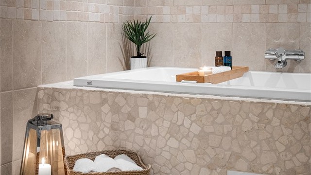 Badet har både badekar og dusjnisje med glassvegg og glassdør