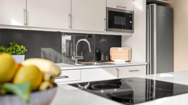 Integrert oppvaskmaskin og nedfelt oppvaskkum i rustfritt stål.