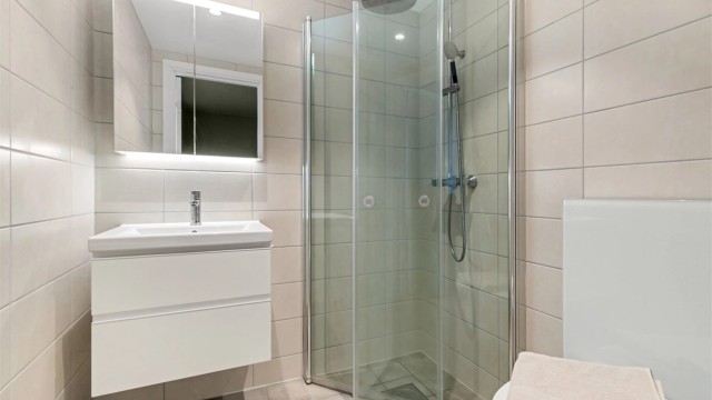 Moderne og flislagt baderom fra 2022 med gulvvarme og downlights. Regnfallsdusj og hånddusj samt foldbare dører