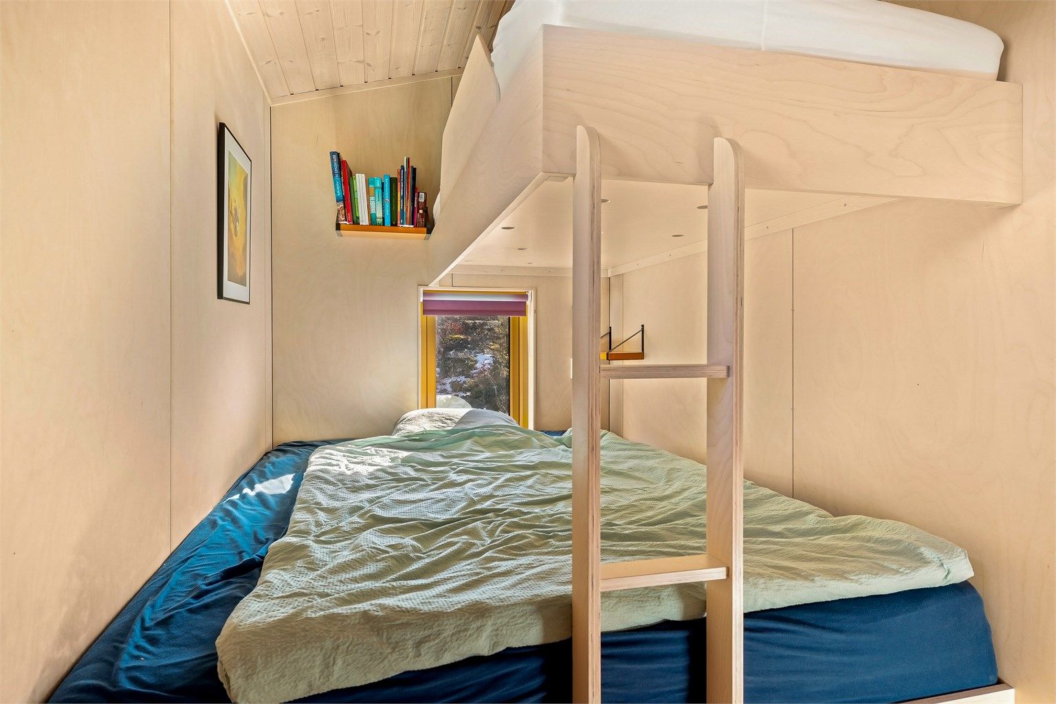 Plassbygde senger utnytter rommet og gjennomført materialbruk gir et ekslusivt preg.