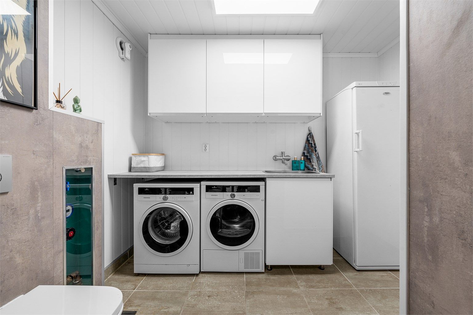 I første etasje ligger et kombinert vaskerom og toalettrom med gulvvarme og god benkeplass.