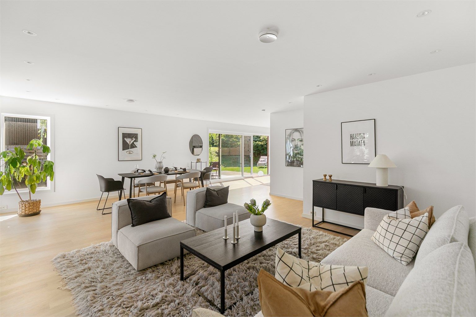 Romslig stue med plass til både sofagruppe og spisebord.