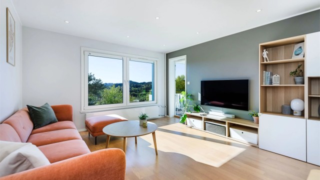 Store vinduer og mange downlights i taket gir godt lys til rommet.