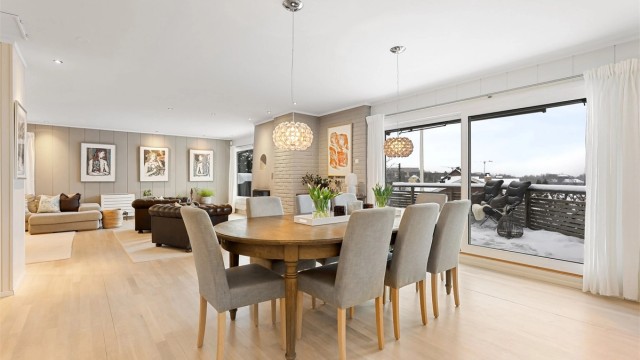 Store vindusflater i stue og spisestue gir rikelig med naturlig lys.