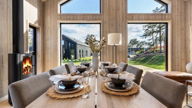 Grånyanser og litt støvete farger, bidrar til at oppholdsrommet føles lunt og koselige til tross for at det er stort og med raus takhøyde.