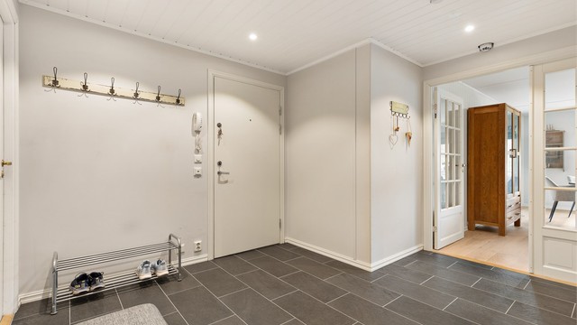 Stor entré med god plass til oppbevaring, fliser på gulv med gulvvarme og downlights i taket. Fra entréen er det videre adkomst inn i til kjøkkenet, stuen, begge soverom, samt bad og wc.
