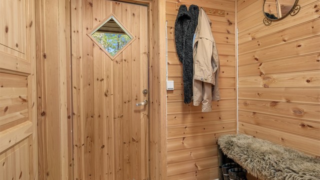 En hyggelig entré ønsker deg velkommen inn, med trepanel som setter den lune hyttetonen allerede fra første steg.