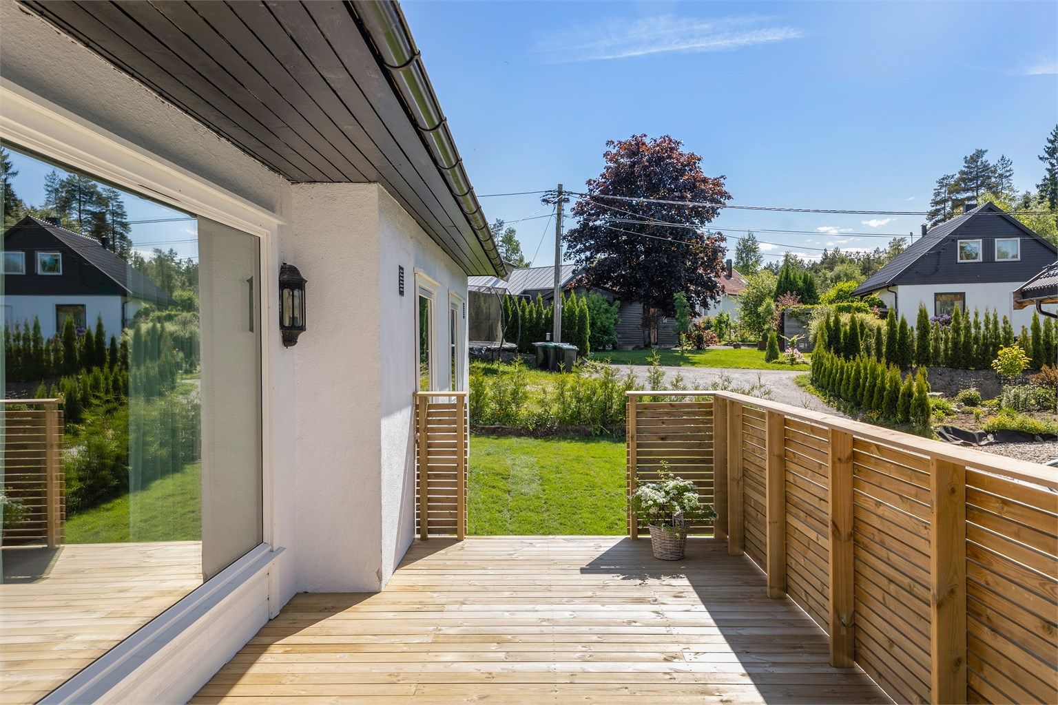 Verandaen har rekkverk i tre og god plass til utemøbler.
