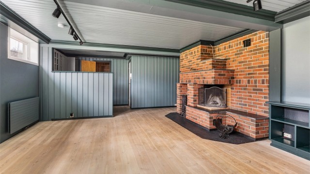 Kjellerstuen har både peis og kjøkkenkrok.