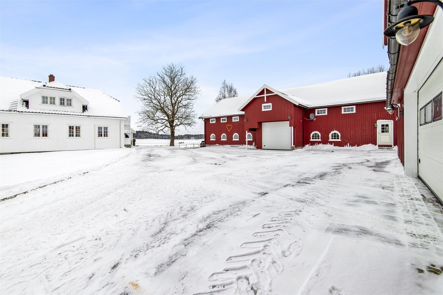 Hele gårdsplassen er asfaltert, slik at det som vist her at det er enkelt å brøyte vinterstid, samt holde det ryddig og pent sommerstid.