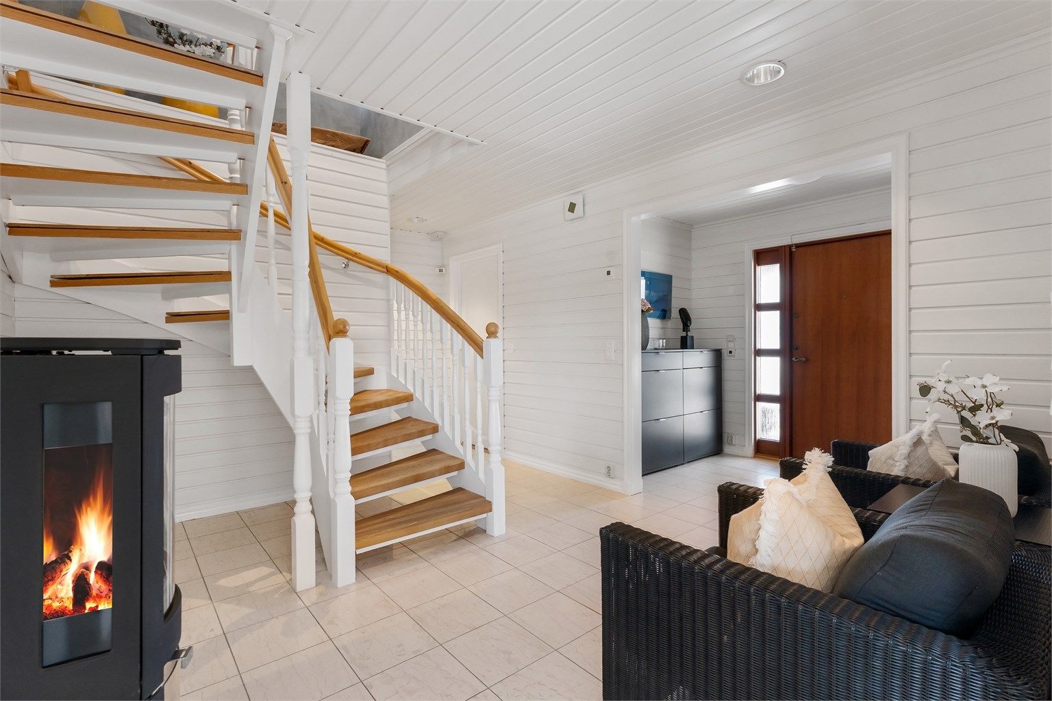 Den innvendige trappen i tre med rekkverk og håndløper binder etasjene sammen.