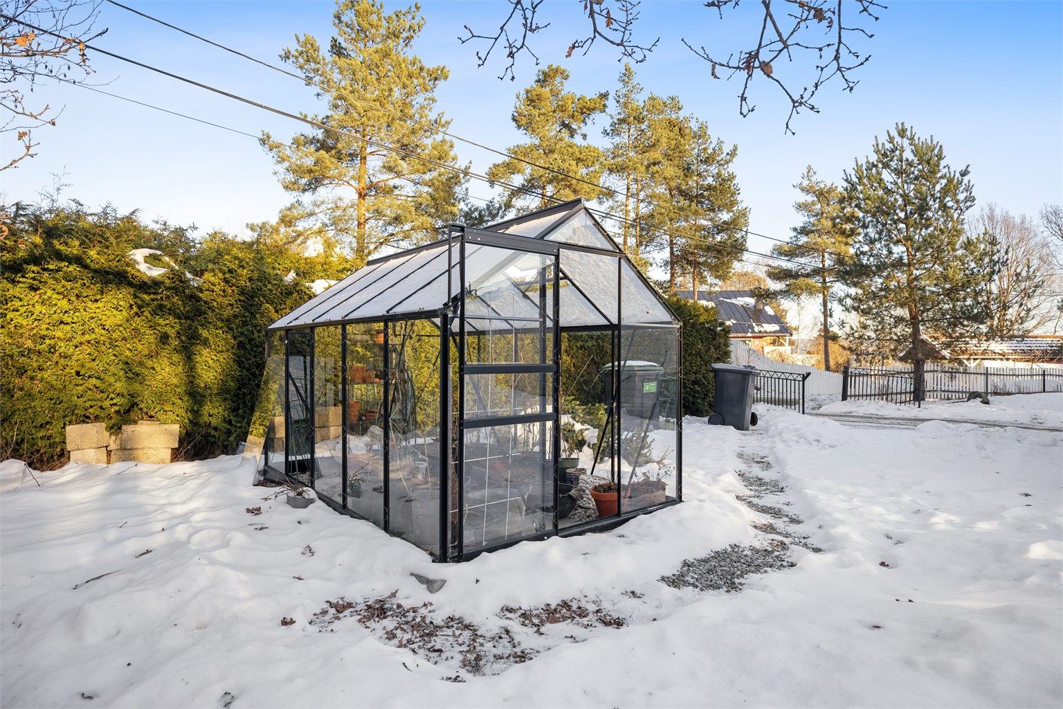 Hagen er frodig, variert og privat, med stor gressplen, et lite naturlig skogholt og små fjellknauser. Drivhuset, oppført i 2025, er plassert under en gammel eik på tomten med optimale dyrkingsforhold.