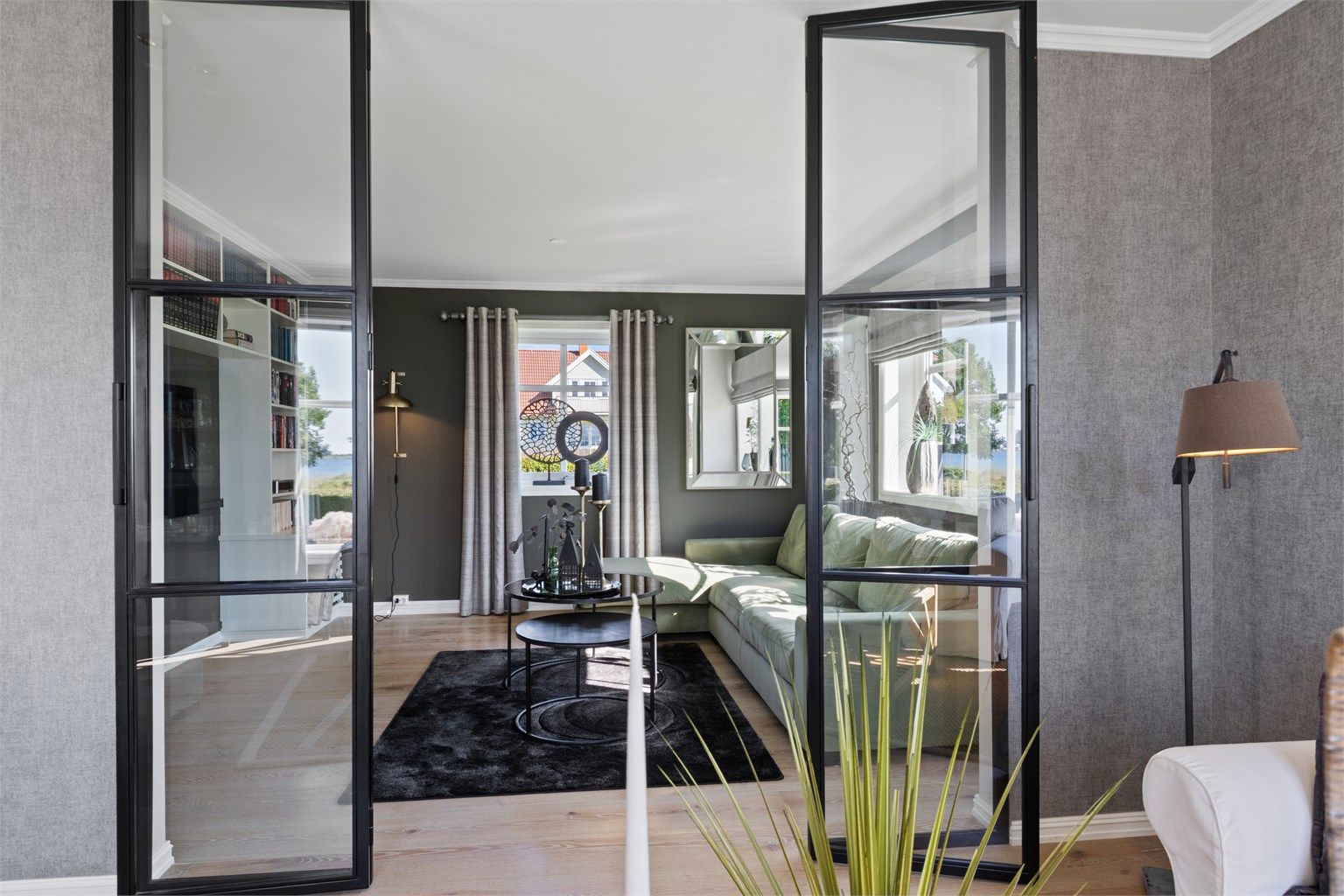 Samme type parkett bidrar til en flytende overgang, og tv-stuen har en plassbygd hylleløsning for bøker, planter og annen dekor.