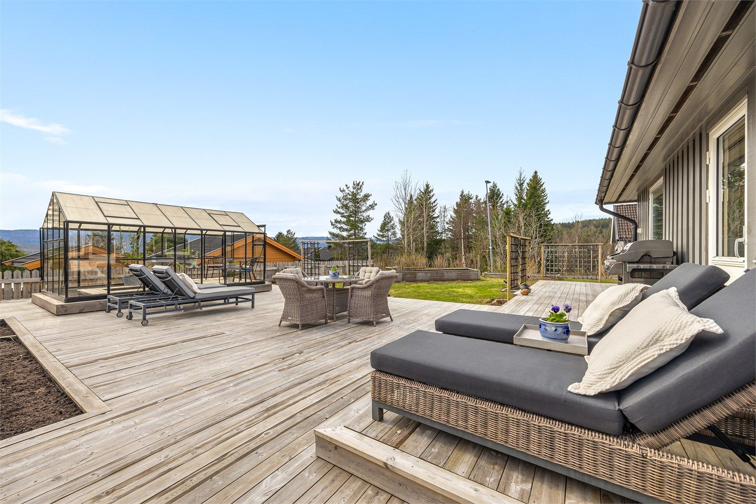 Den romslige treterrassen strekker seg langs store deler av husets sørside