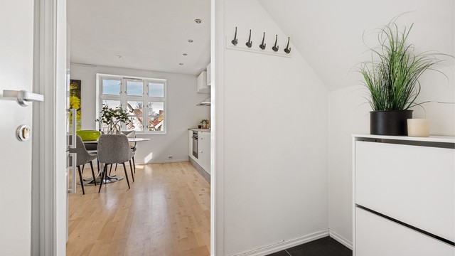 Fra felles inngangsparti med en av de andre leilighetene, kommer man via trapp opp til 2.etg.
Liten entré med plass til å henge av yttertøy. Fliser på gulv.