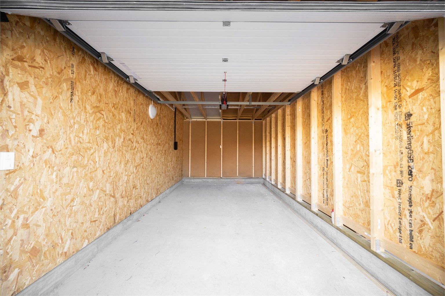 Garasjeplassen som medfølger boligen er på ca. 17 m² og er utstyrt med elektrisk og fjernstyrt portåpner.