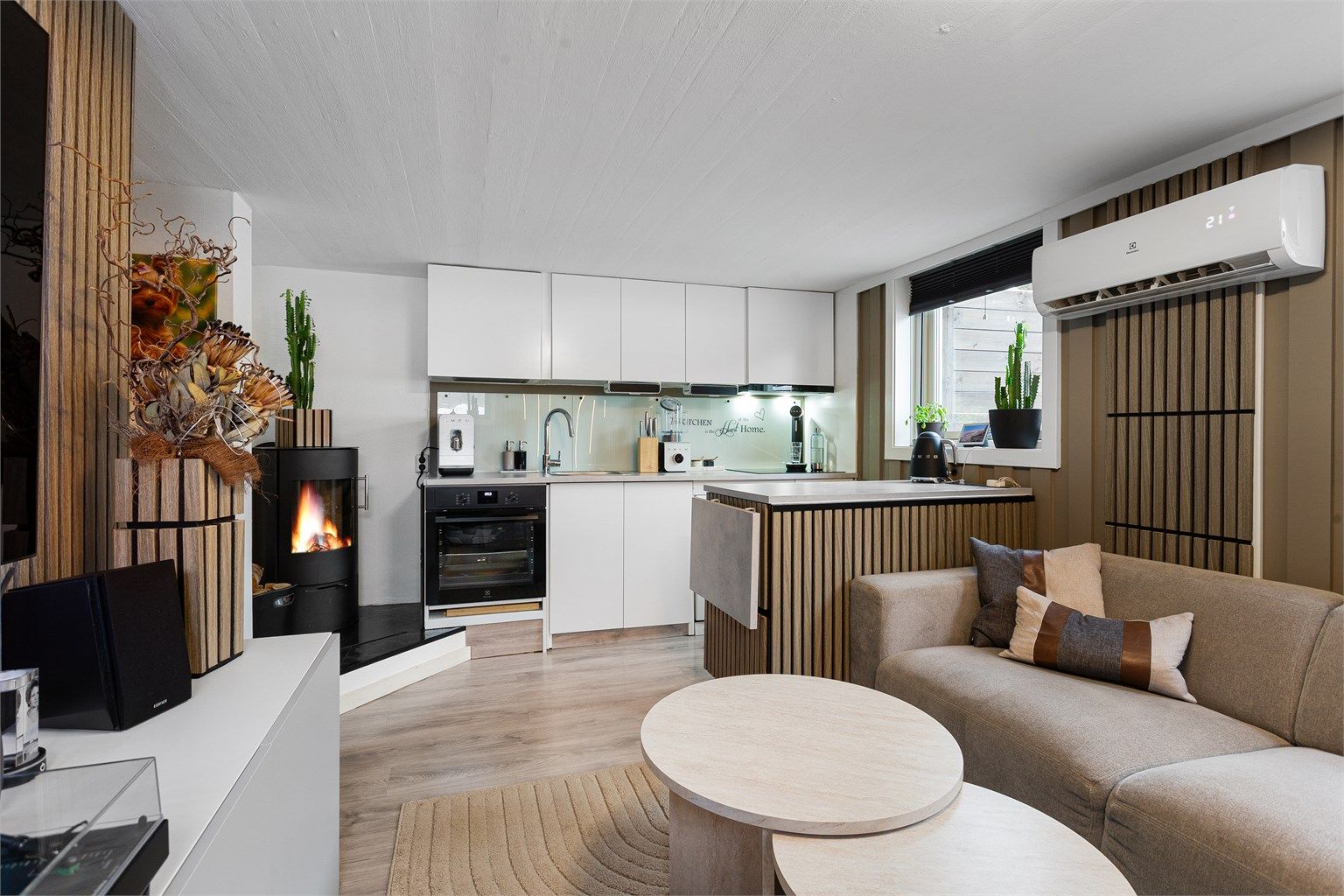 Åpen kjøkken- og stueløsning med frittstående peisovn fra 2014 samt luft-til-luft varmepumpe fra 2022 - Hybel