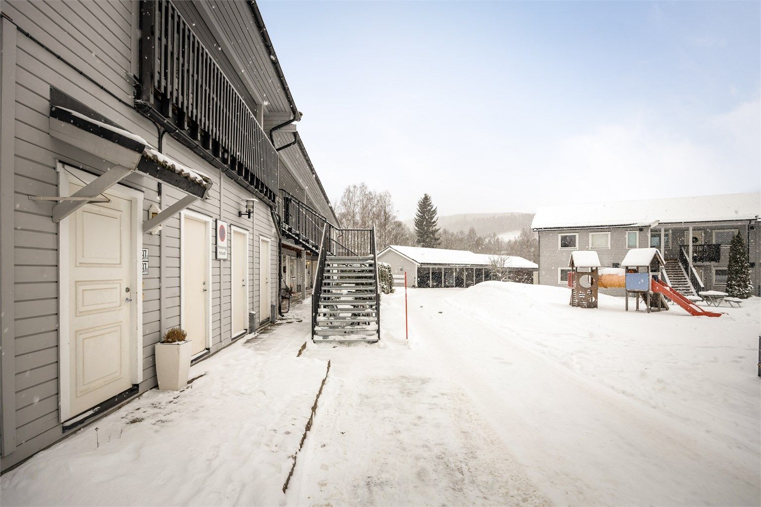 Felles overbygget inngangsparti og felles gang med naboleiligheten i 1. etasje