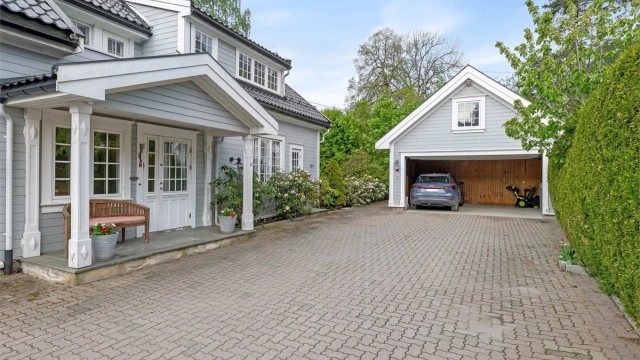 Gårdsplassen er steinbelagt og gir god plass til parkering for flere biler.