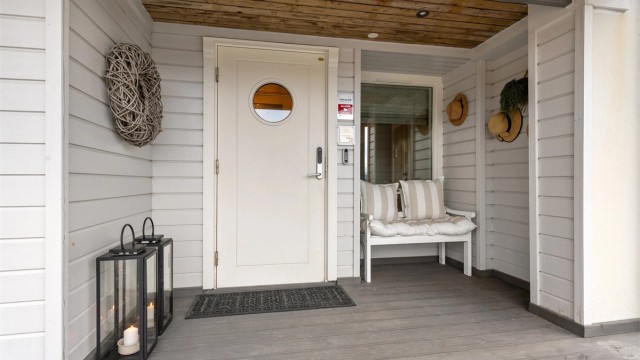 Overbygd inngangsparti med entrédør med elektrisk kodelås