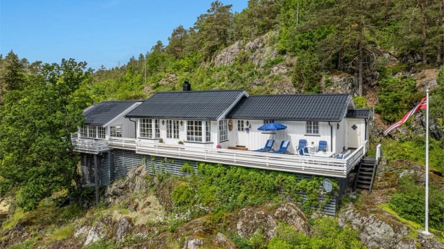 Terrassen strekker seg rundt hele hytta og gir rikelig med plass til spiseplasser, solstoler og loungegrupper.