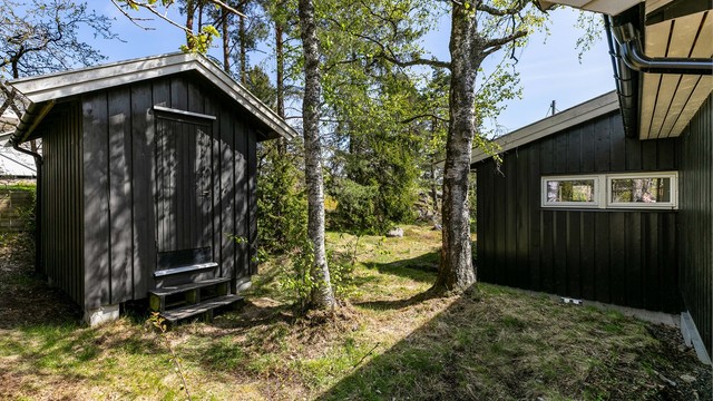 På baksiden av tilbygget står en praktisk hage-/redskapsbod.