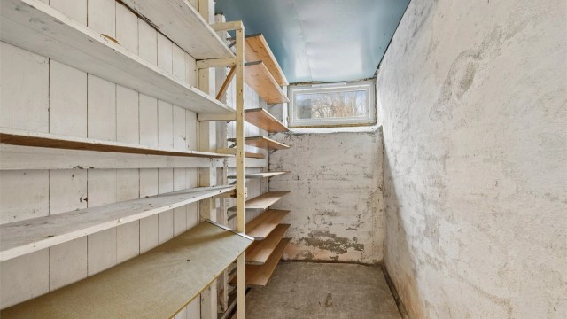 En av de mange bodene i kjelleren, med praktiske hyller for organisering.