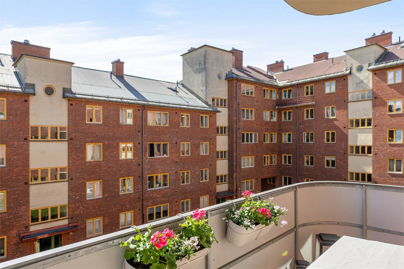 Balkongen vender mot en rolig og grønn bakgård med klassisk bygårdsbebyggelse og lite innsyn.