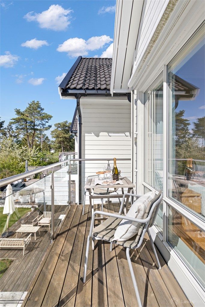 Balkongen har rekkverk i metall og glass, som sikrer utsikten og gir et moderne uttrykk