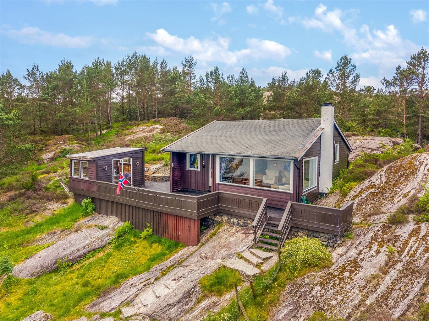 Eiendommen ligger usjenert til, omkranset av natur og med sjøen rett nedenfor.