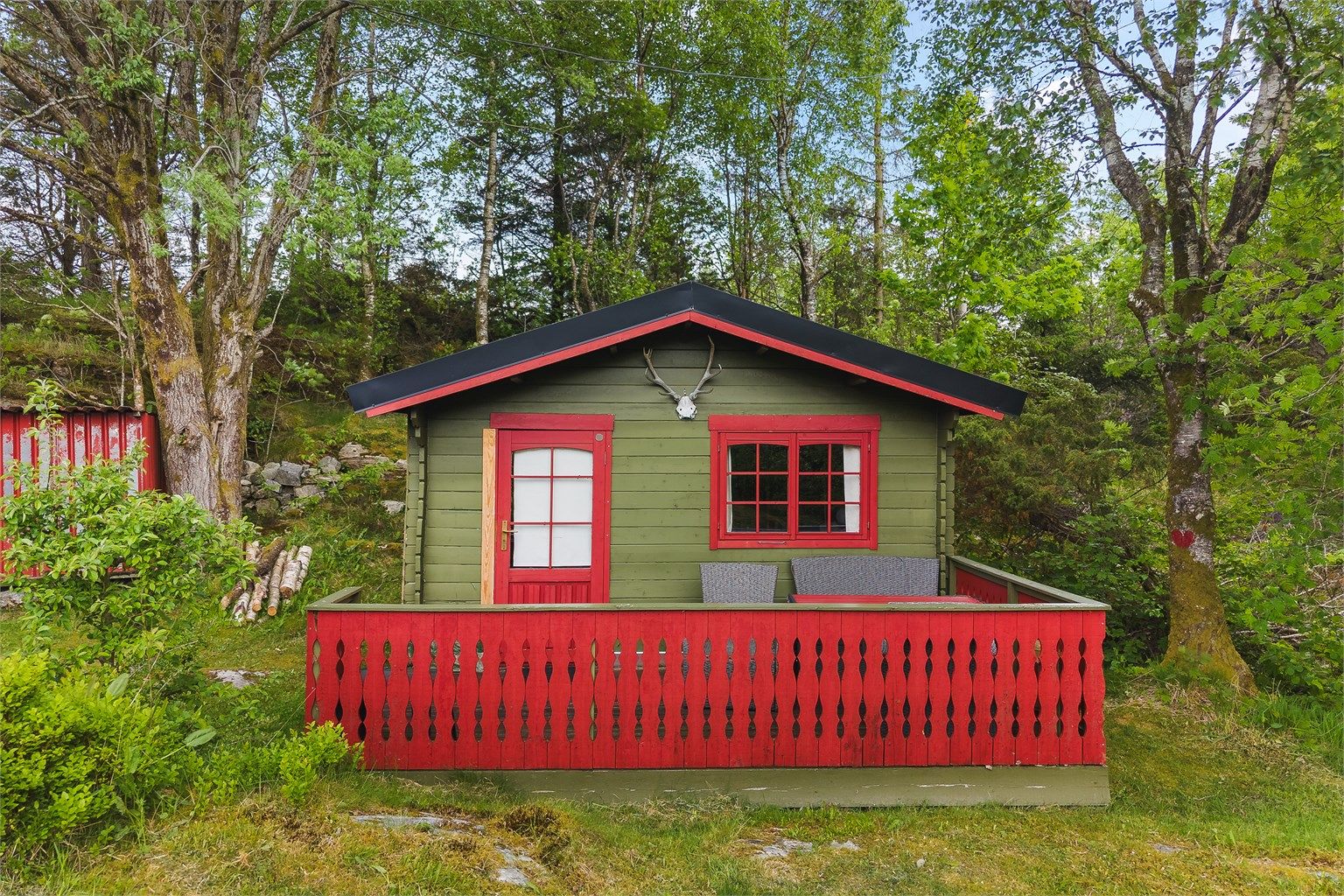 På tomten står et frittstående anneks med egen terrasse, samt boder for oppbevaring.