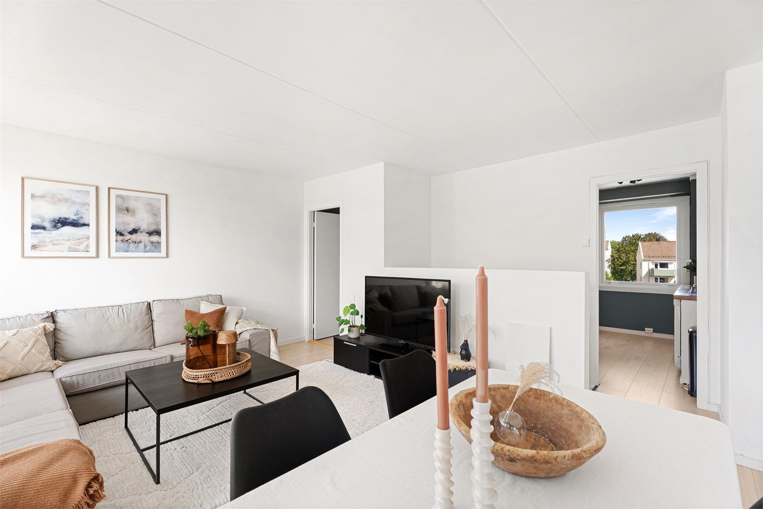 Leiligheten oppleves svært lys med hvitmalte flater og pent laminatgulv. Stuen er romslig med plass til stor sofagruppe og spisebord.