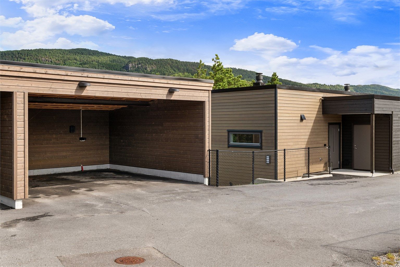 Carporten ligger i umiddelbar nærhet til boligens inngangsparti.