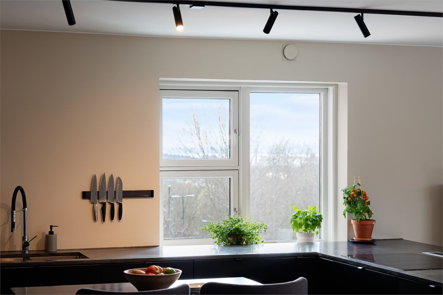 Innredningen har glatte fronter og benkeplater av laminat med kjøkkenvask.