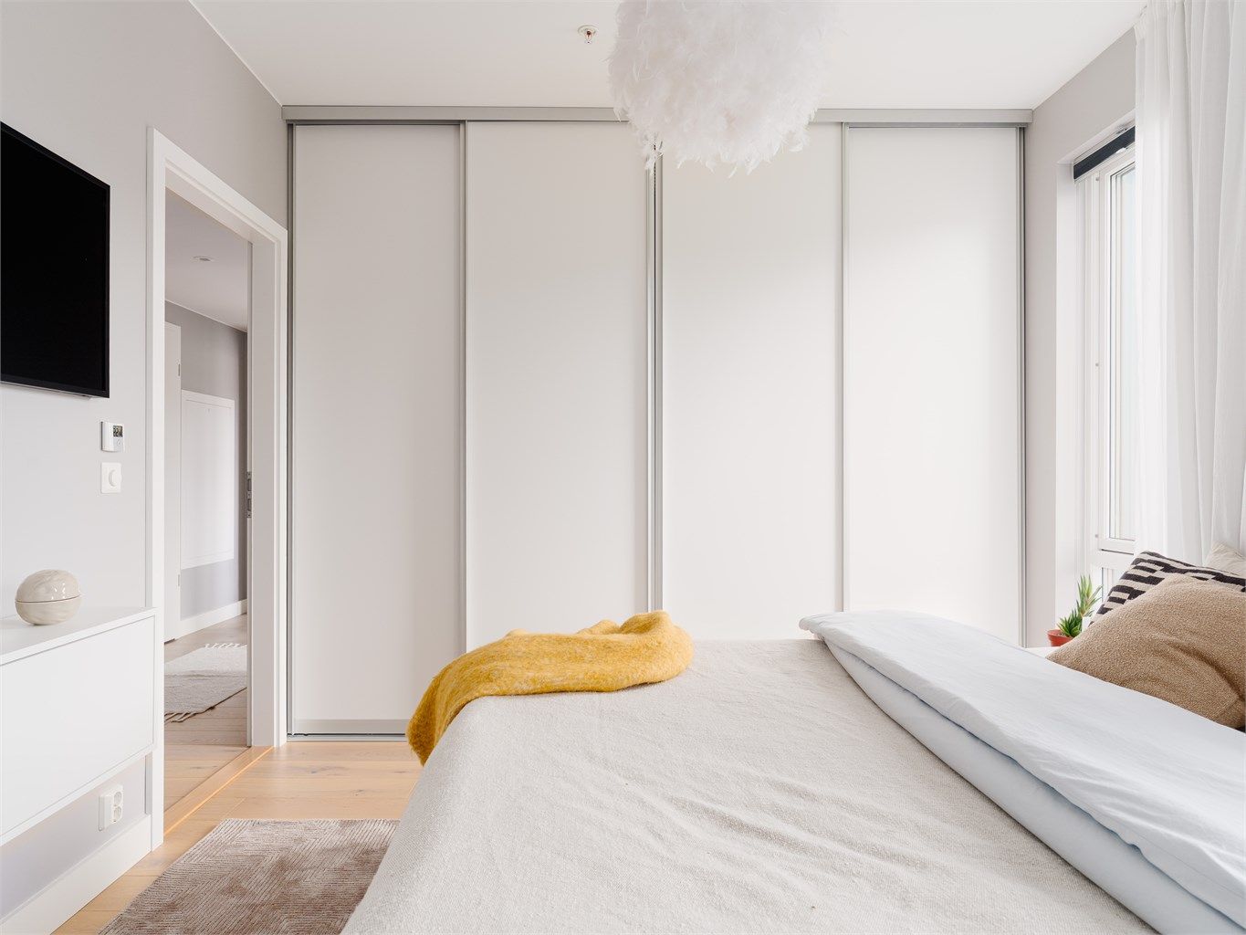 En stor skyvedørsgarderobe byr på ytterligere oppbevaring i dette romslige soverommet.