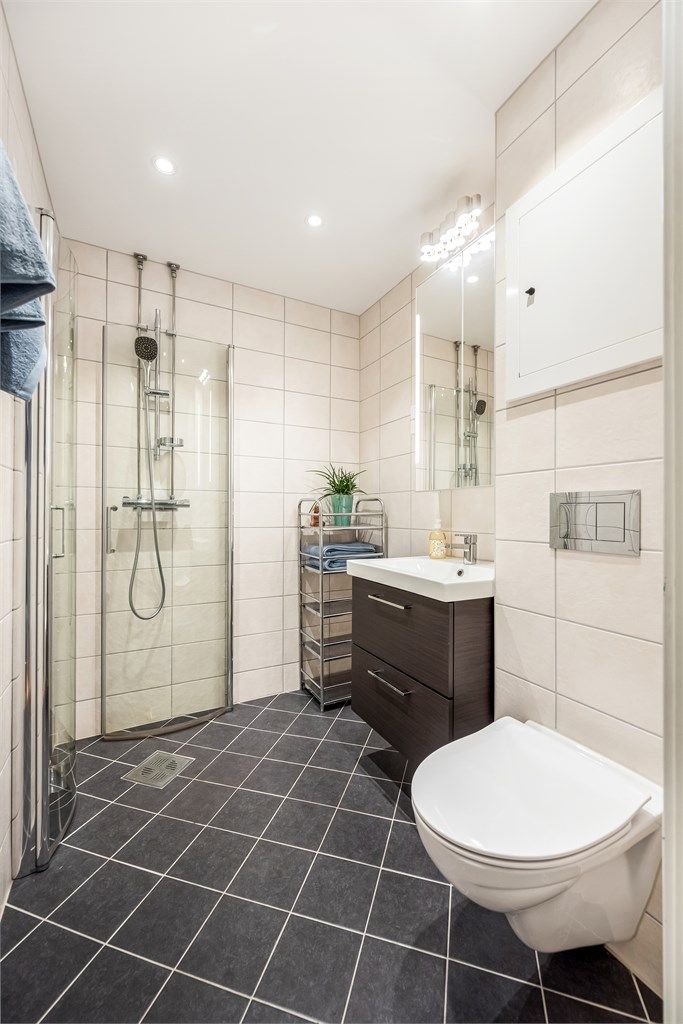 Badet er utstyrt med vegghengt toalett, innfellbare glassdører og downlights i himlingen.