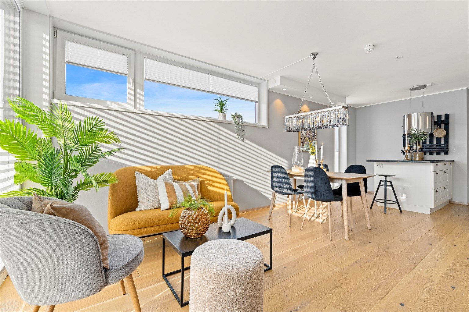 Store vindusflater gir rikelig med naturlig lys til spiseplassen og stuen.