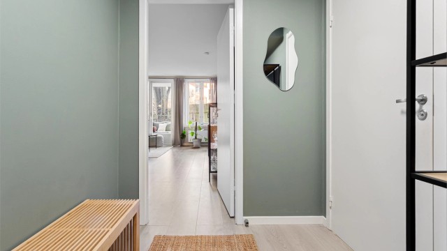 Rommet har malte overflater, laminat på gulv og lyd- og brannklassifisert inngangsdør.