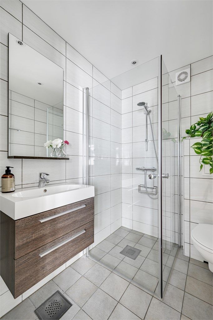 Badet har flislagte overflater og moderne innredning. 