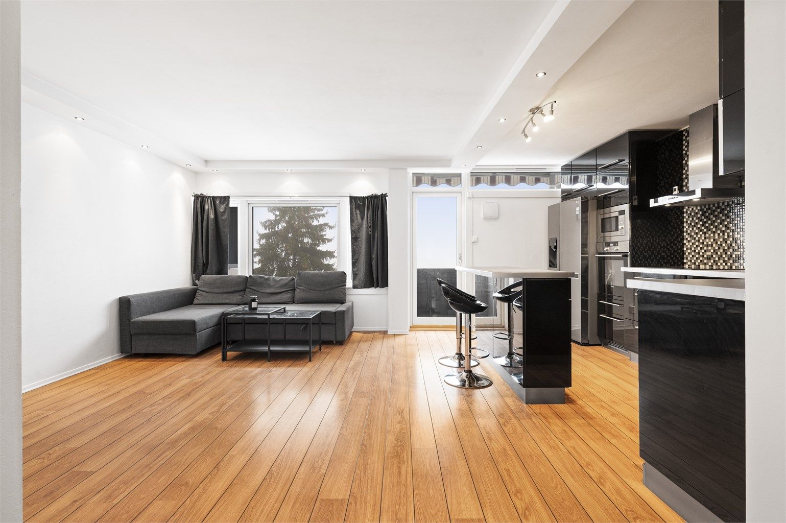 Stuen har en luftig atmosfære med store vindusflater. 