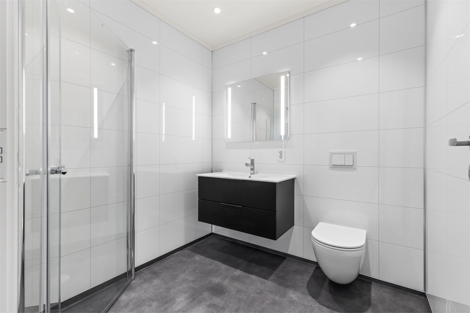 Badet tilknyttet hovedsoverommet har lekker baderomsinnredning og varmekabler i gulvet.